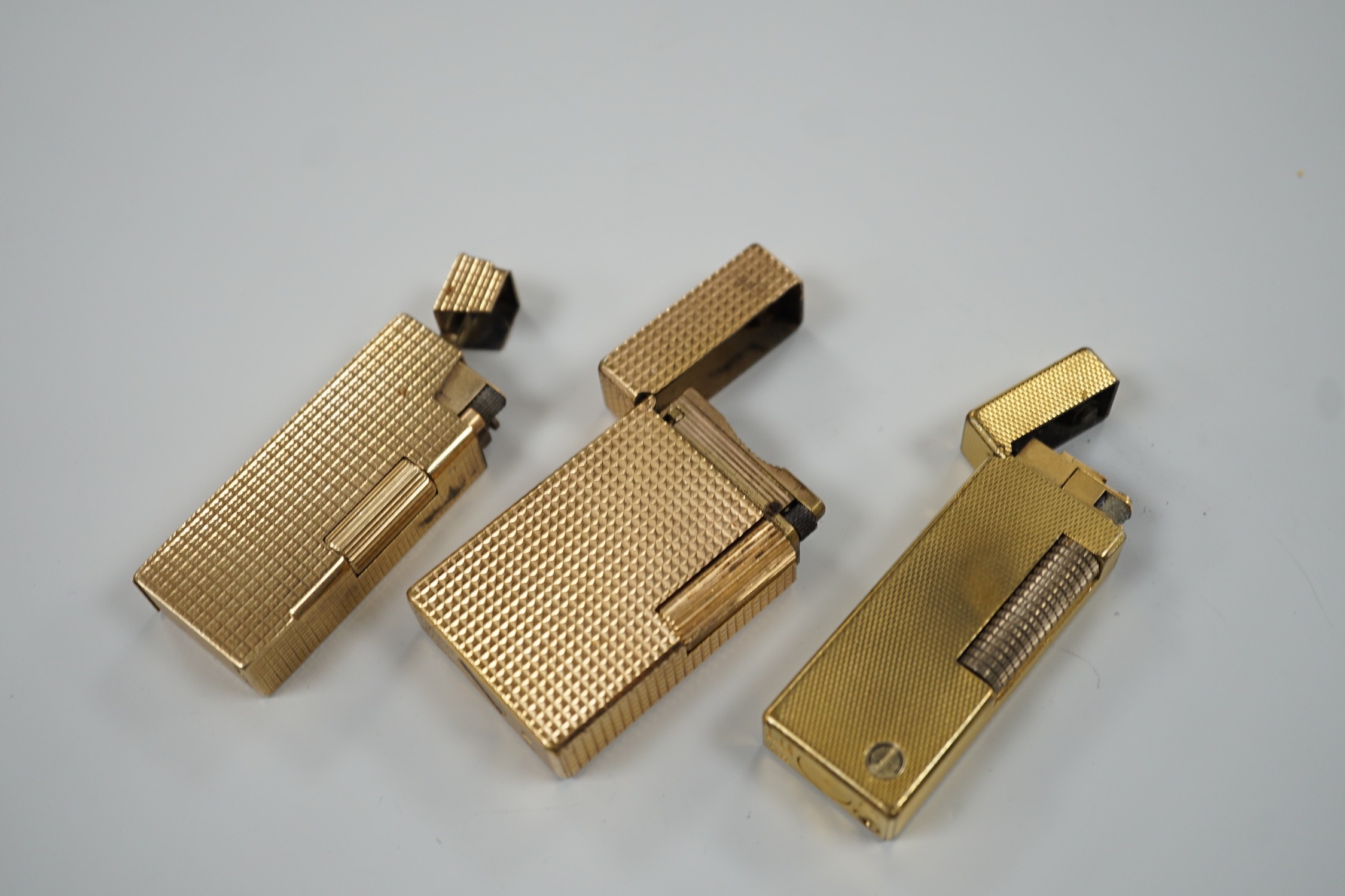 Three Dupont gilt metal lighters